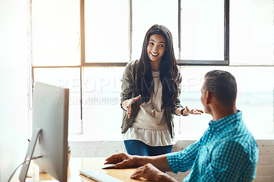 Buy stock photo Cropped shot of an attractive young businesswoman giving some advice to a male colleague while working in a modern office