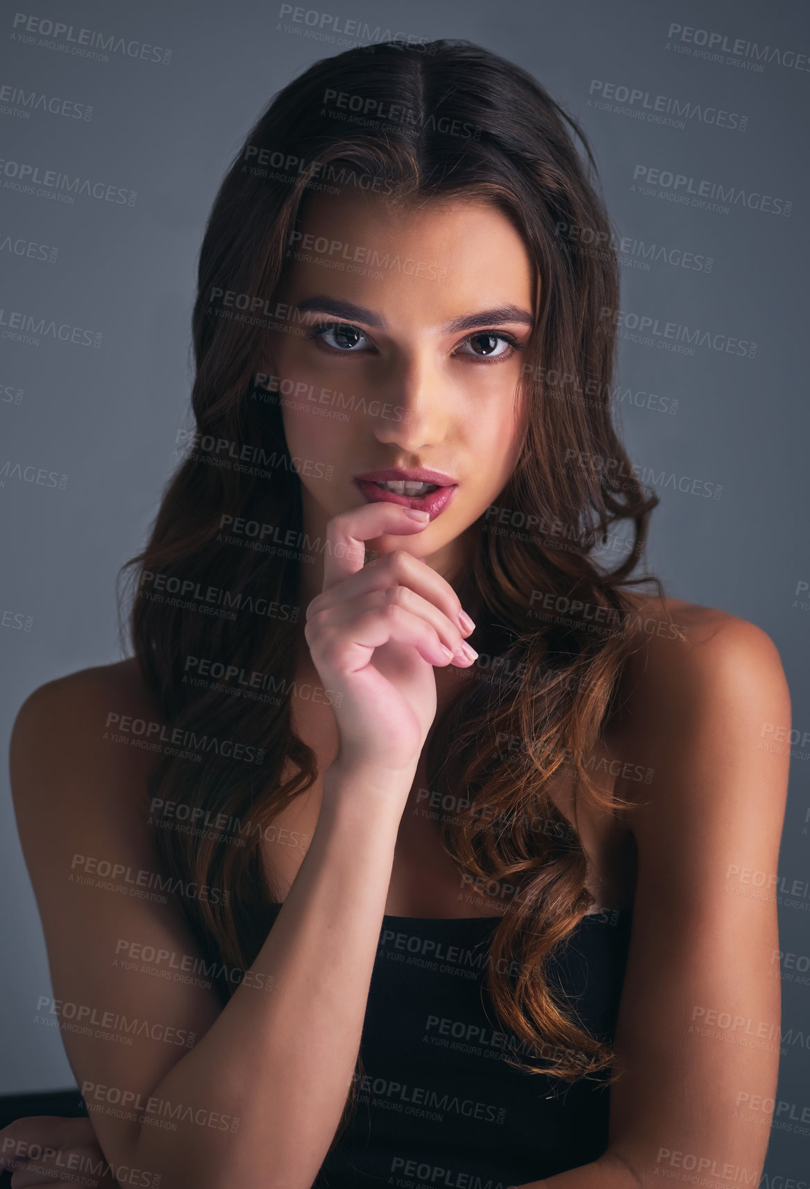 Buy stock photo Studio shot of an attractive young woman posing against a grey background