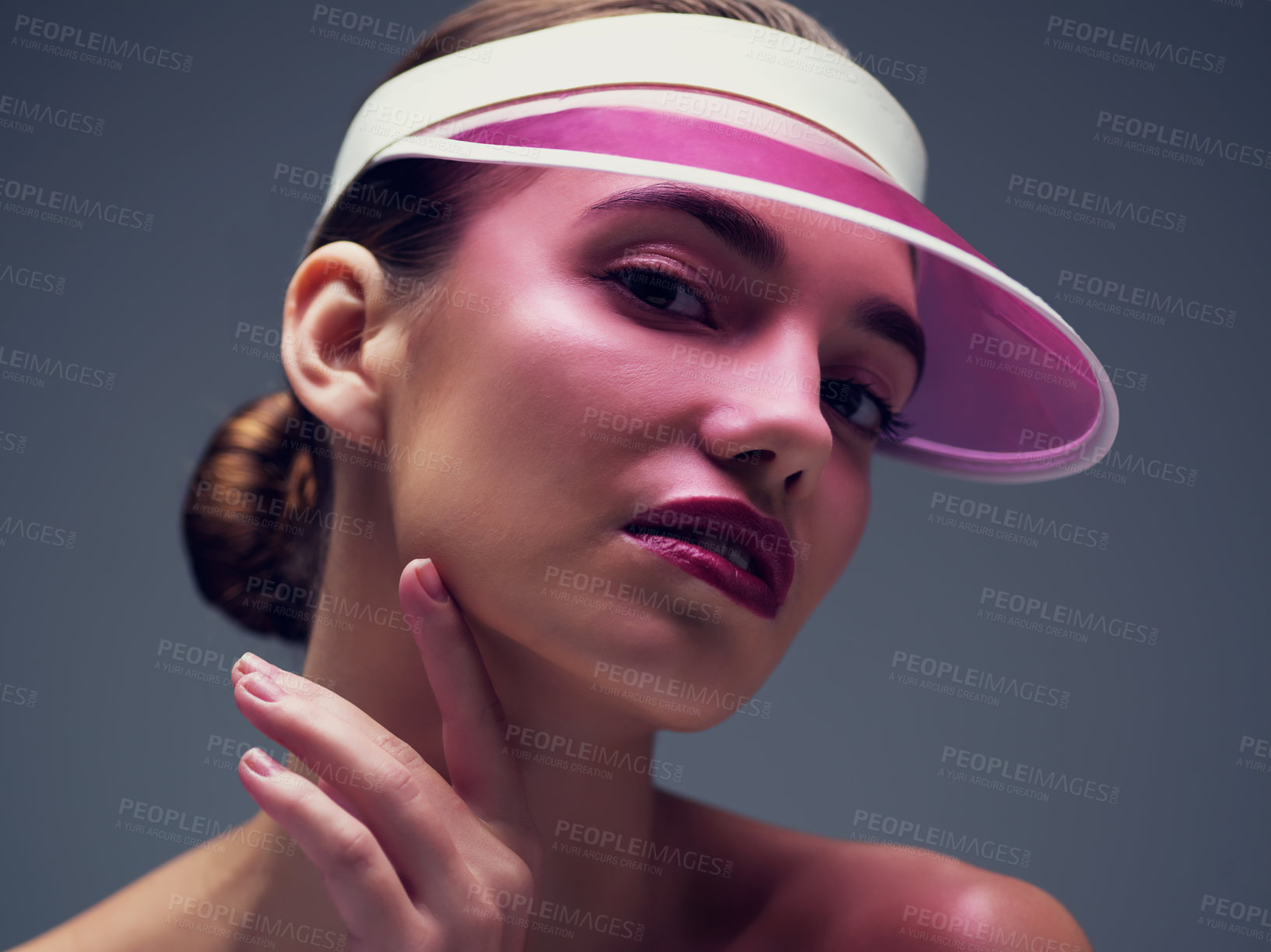 Buy stock photo Makeup, portrait and woman with neon visor, confidence and cosmetics for creative skincare in studio. Art, color and face of serious girl with retro cap, skin glow or unique beauty on grey background