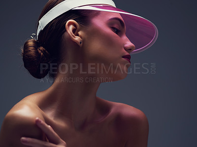 Buy stock photo Makeup, beauty and woman with neon visor, confidence and unique cosmetics for creative skincare in studio. Art, color and face of serious girl with retro cap, skin glow or thinking on grey background