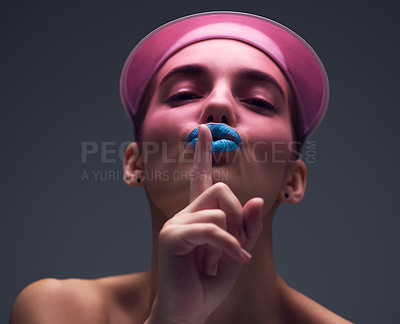 Buy stock photo Studio shot of an attractive young woman wearing a pink retro cap posing against a gray background