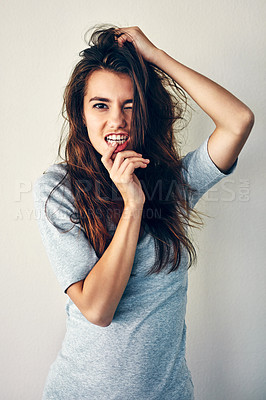 Buy stock photo Studio shot of an attractive young woman posing with her hand in her hair