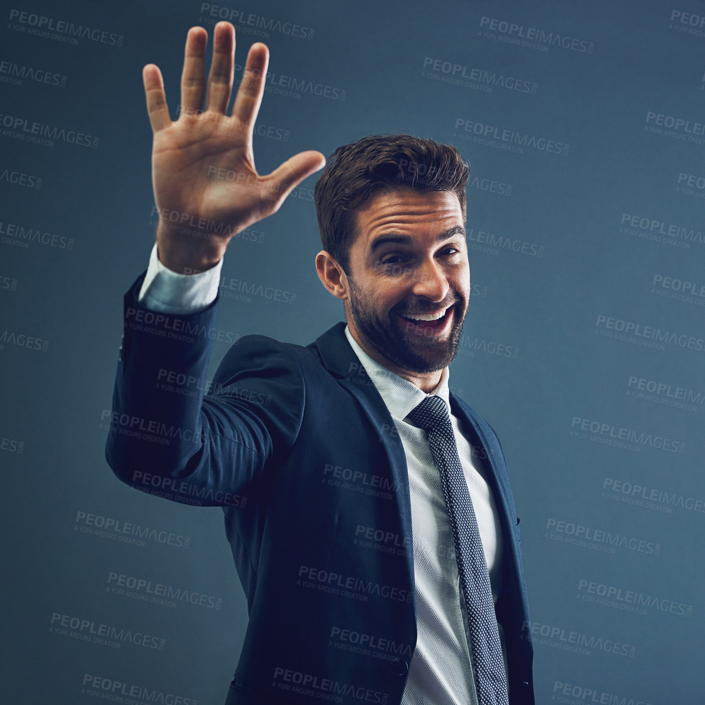 Buy stock photo Studio portrait of a handsome young businessman gesturing for a high five against a dark background