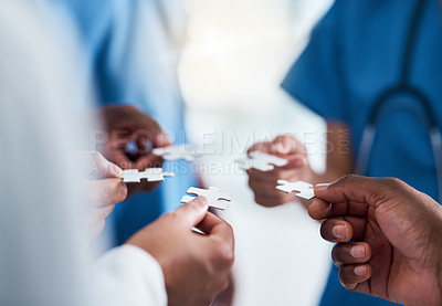 Buy stock photo Hands, puzzle and teamwork of doctors in hospital for team building, synergy and planning. Collaboration, nurses and jigsaw pieces for healthcare, medical solution and strategy, cooperation and trust