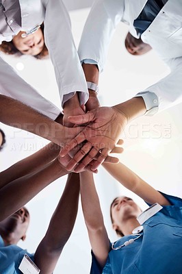 Buy stock photo Medical, team and hands together with support in hospital for healthcare success, surgery celebration and diversity. Doctor, collaboration and people in low angle with nurse, solidarity or motivation