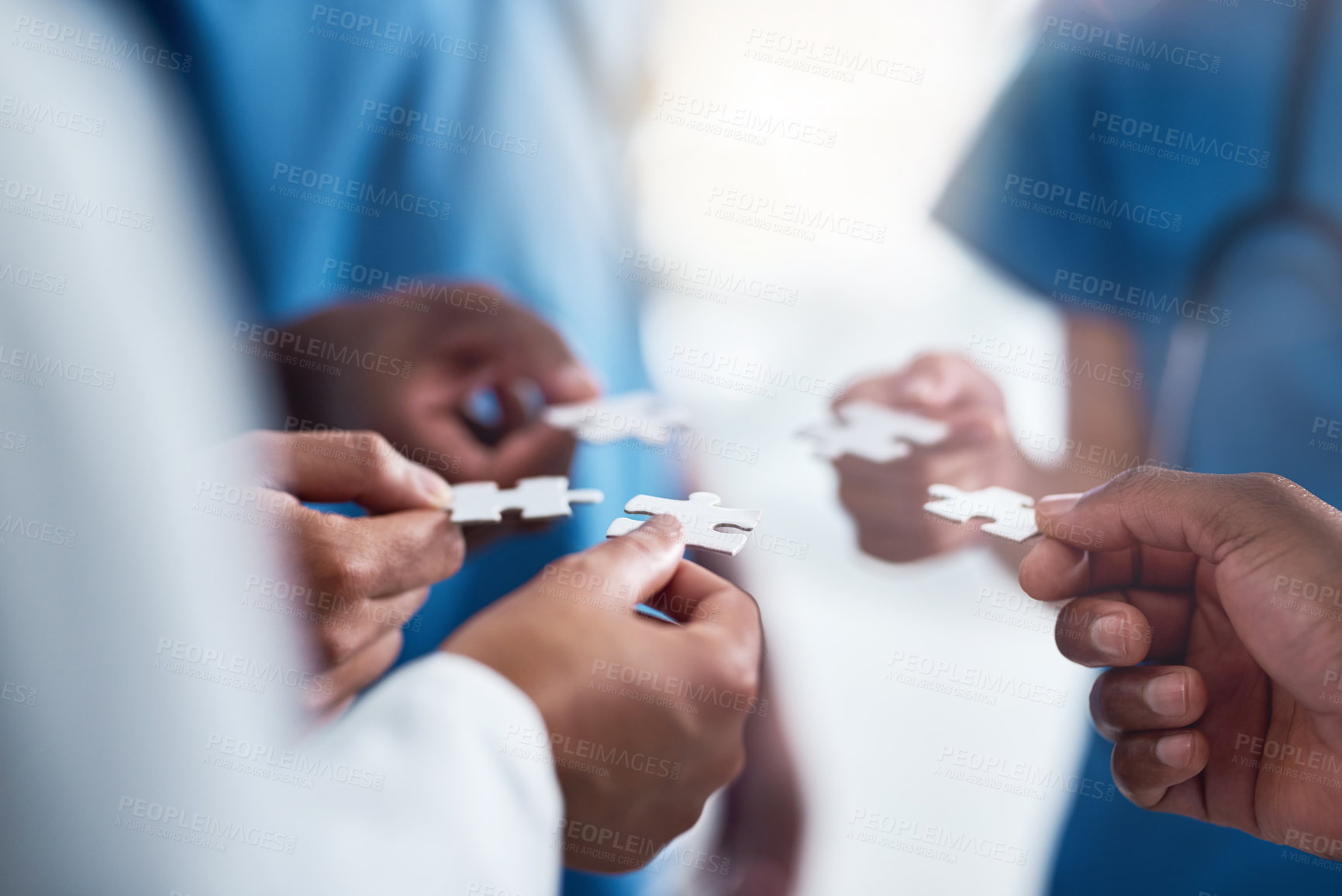 Buy stock photo Hands, puzzle and collaboration of medical doctors in hospital for team building, synergy and planning. Teamwork, nurses and jigsaw pieces for healthcare, solution and strategy, cooperation and trust