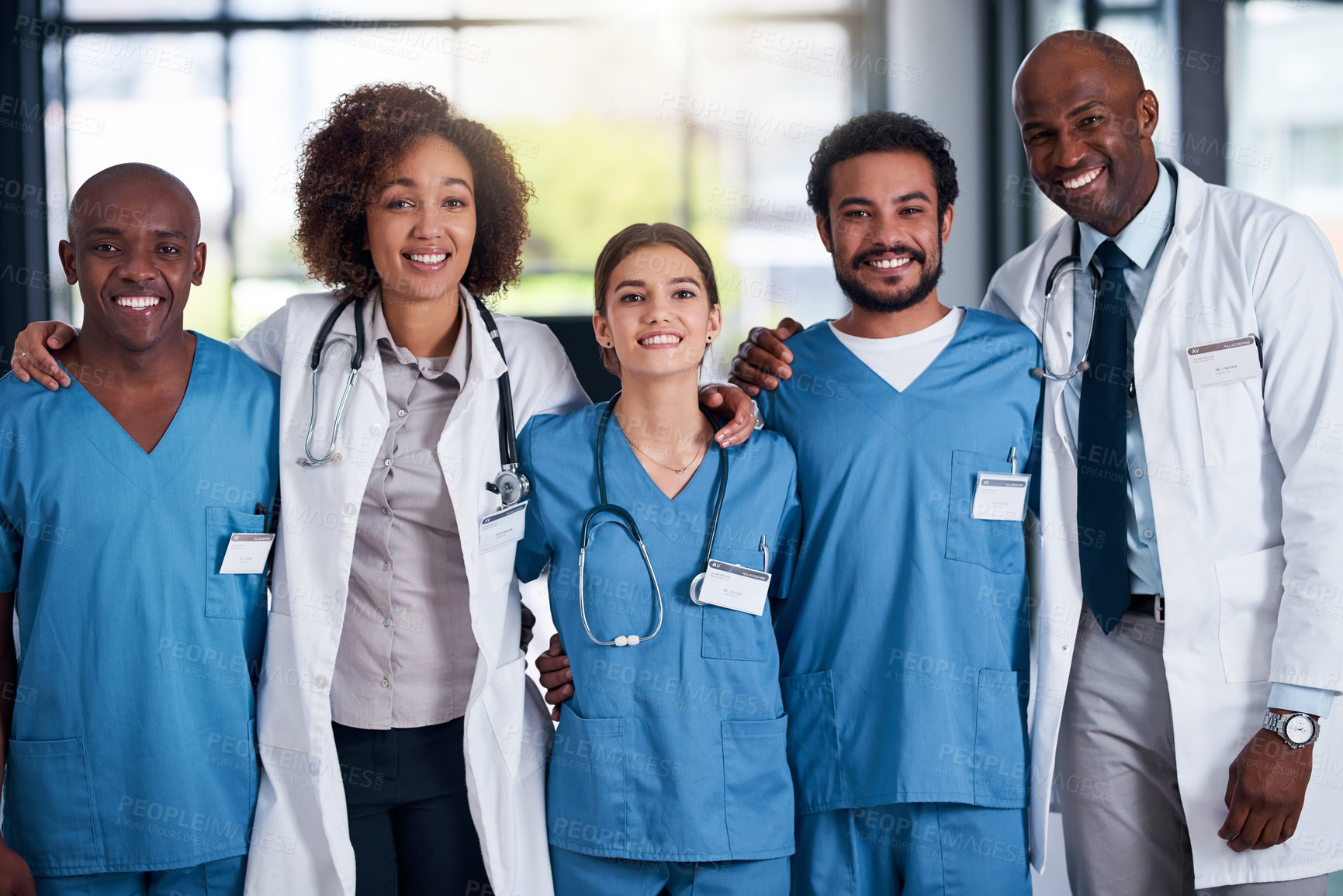 Buy stock photo Portrait, group and doctors with embrace, healthcare and collaboration with interns, smile and hospital. Team, men and women in uniform, medical professional and together to help, happy and clinic