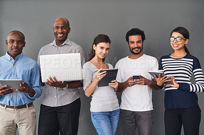 Buy stock photo Studio shot of businesspeople using wireless technology against a gray background