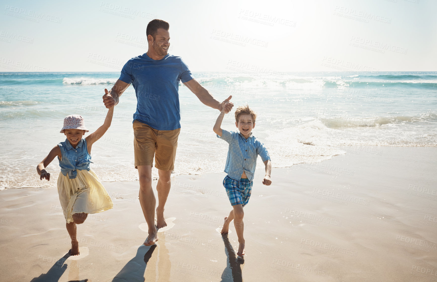 Buy stock photo Happy, holding hands and dad with children at beach on holiday, vacation and tropical adventure. Family, travel and kids with father by ocean for bonding, playing in waves and fun outdoors on weekend