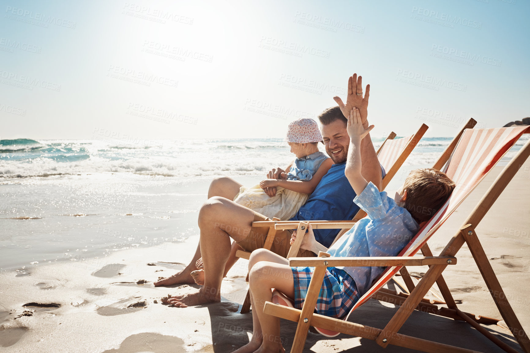 Buy stock photo High five, beach and father with children on chair for holiday, vacation and relax on tropical island. Family, travel and dad with kids by ocean for bonding, playing and fun in nature on weekend