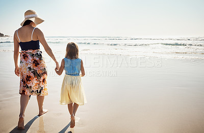 Buy stock photo Rear view shot of a mother and her little daughter bonding together at the beach