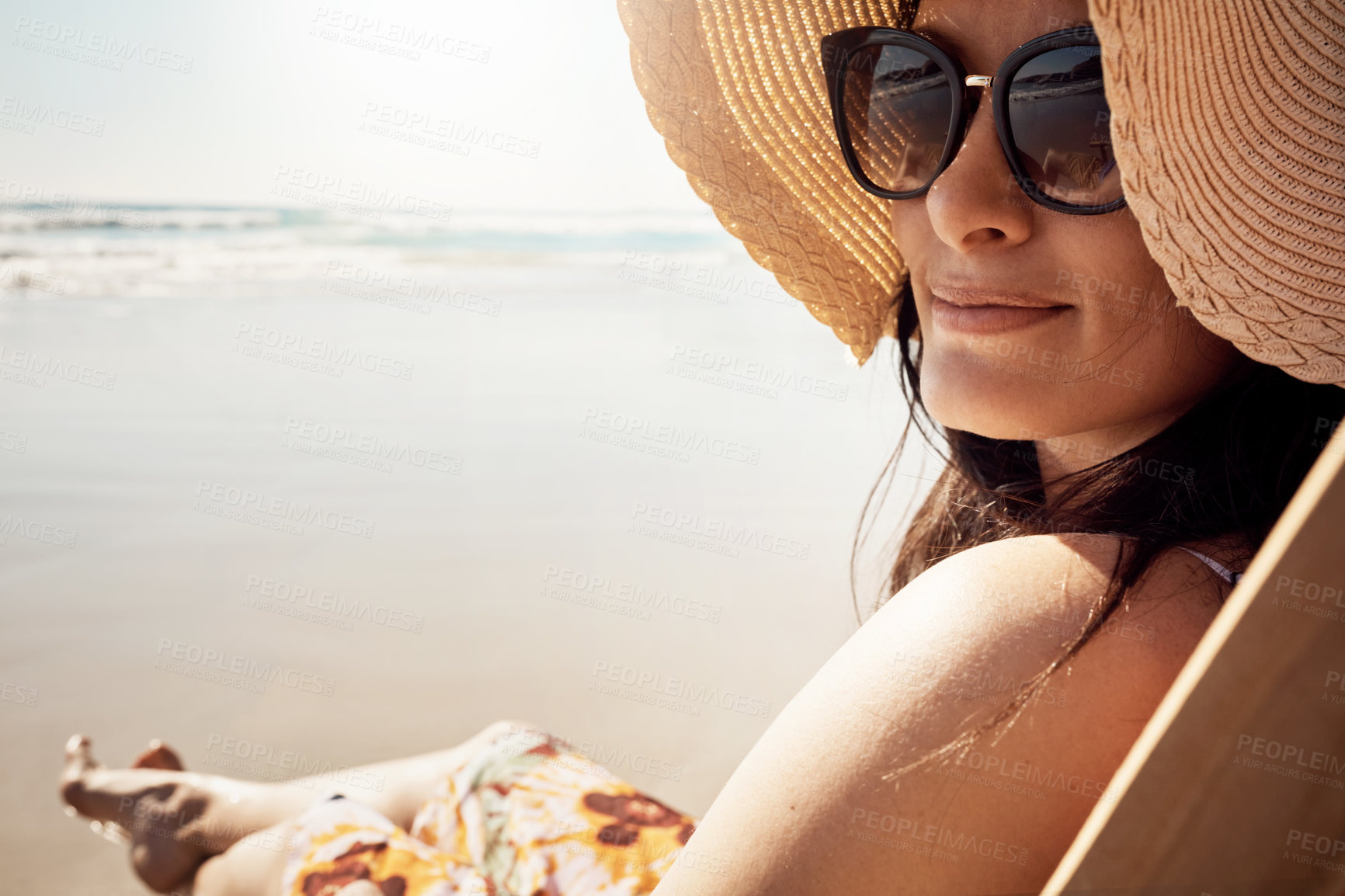 Buy stock photo Woman, shades and relax at beach with water, sand and hat for vacation by ocean in summer. Female person, smile and happy in Miami for tropical holiday, peace or travel with sunset and sunglasses