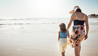 Buy stock photo Rear view shot of a mother and her little daughter bonding together at the beach