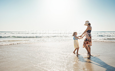 Buy stock photo Mom, girl and vacation with dancing at beach, waves and holding hands with child by mockup space in summer. Holiday, mother and daughter with connection, bonding and love by sea with care in Croatia