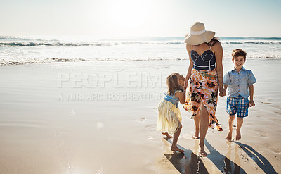 Buy stock photo Shot of a mother bonding with her two little children at the beach