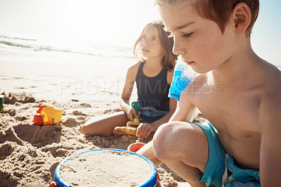 Buy stock photo Children, learning and siblings at a beach for sandcastle, fun and bonding in nature on summer, break or vacation together. Travel, family and kids at the ocean with love, care and games with toys