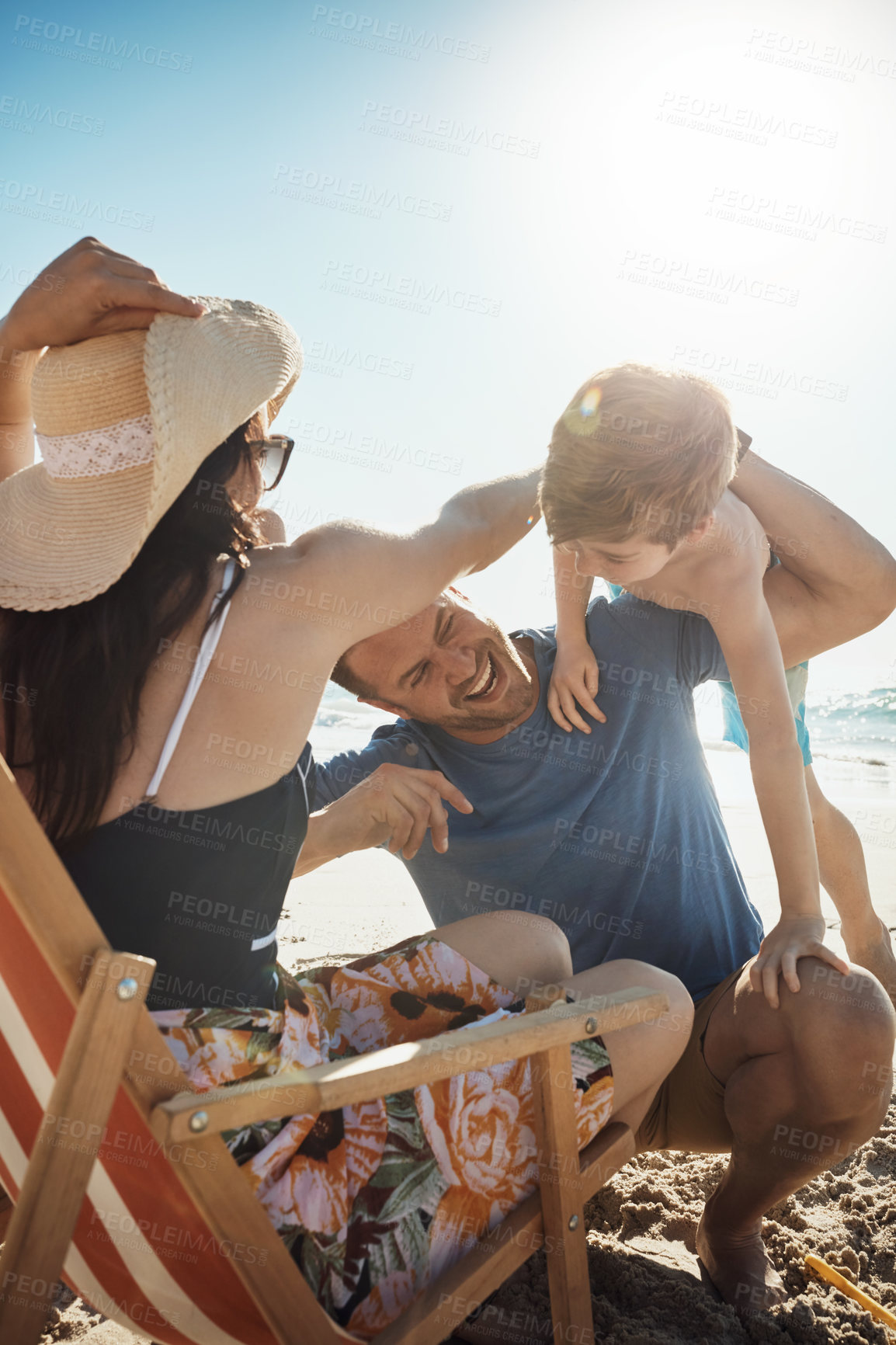 Buy stock photo Beach, chair and happy family with piggyback games, fun and playing, freedom and bonding in nature together. Laughter, love and kid with parents at sea for travel, energy and adventure in Cancun