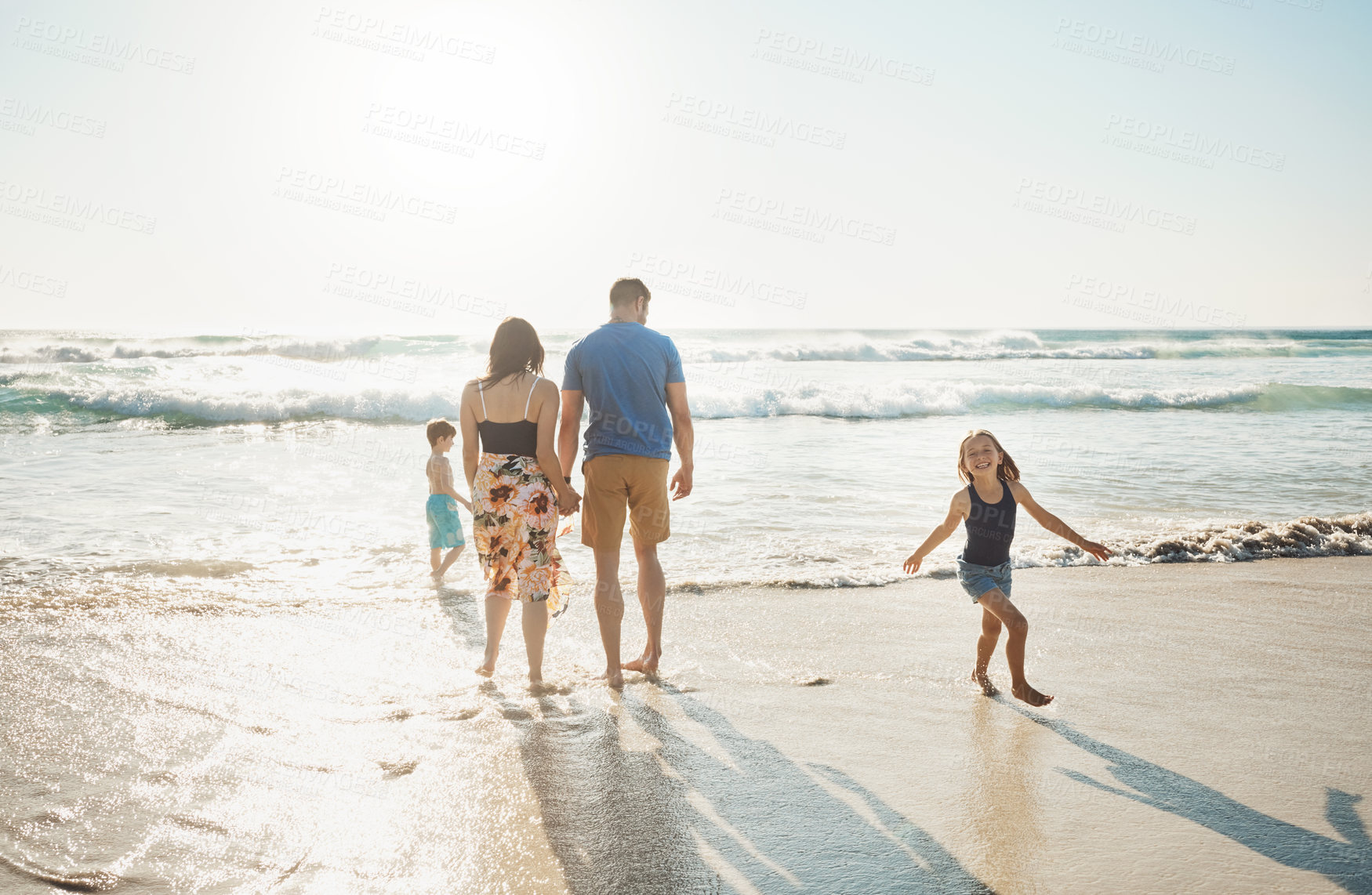 Buy stock photo Shot of a family of four spending the day at the beach