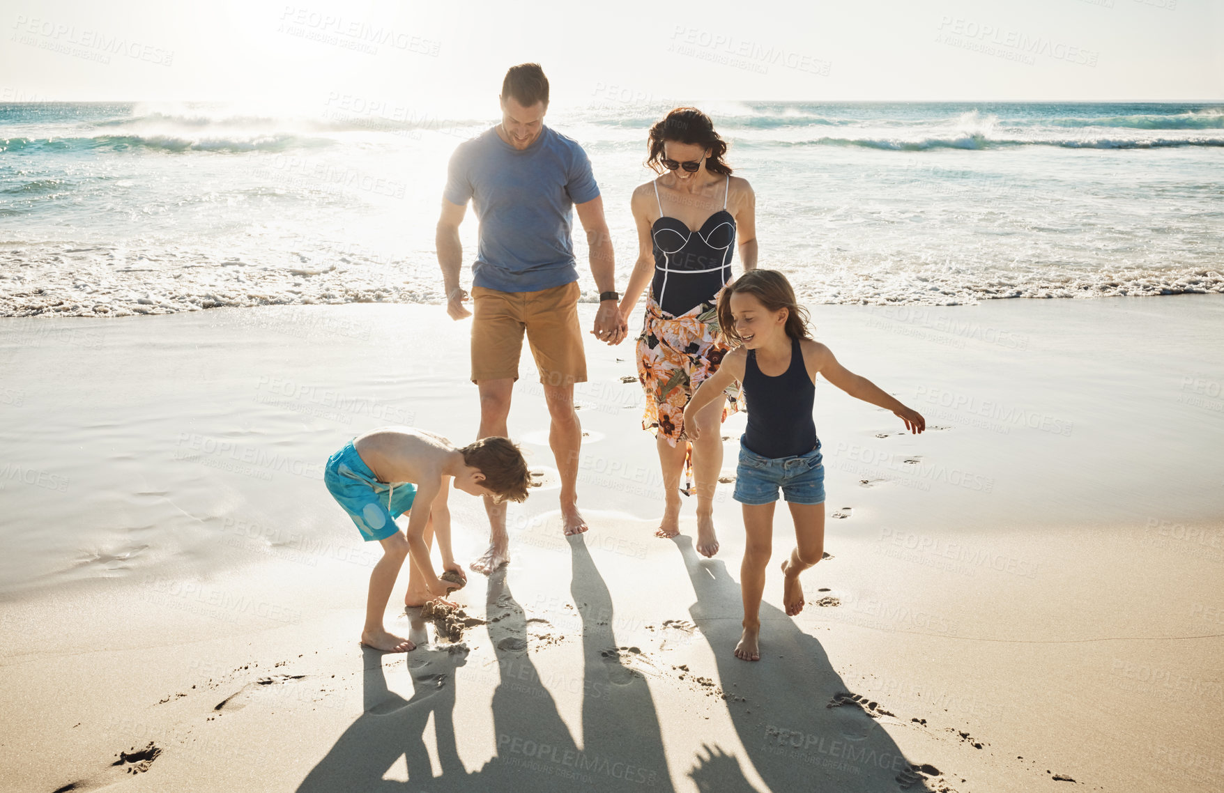 Buy stock photo Shot of a family of four spending the day at the beach