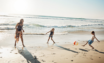 Buy stock photo Shot of a young woman spending the day at the beach with her kids