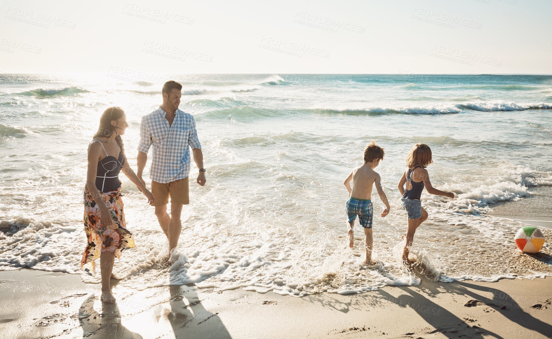 Buy stock photo Shot of a family of four spending the day at the beach