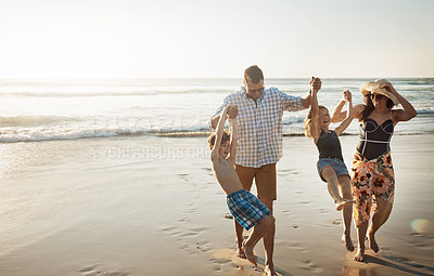 Buy stock photo Shot of a family of four spending the day at the beach