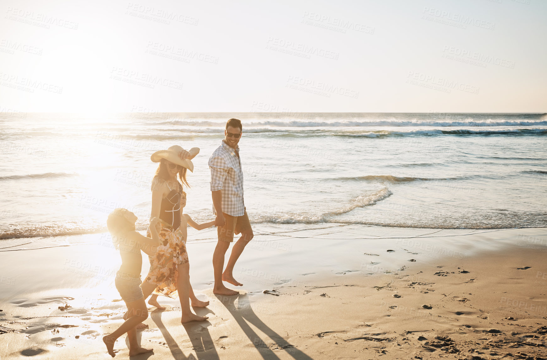 Buy stock photo Shot of a family of four spending the day at the beach