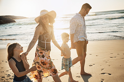 Buy stock photo Shot of a family of four spending the day at the beach