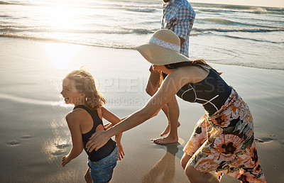 Buy stock photo Shot of a couple at the beach with their young daughter