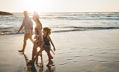 Buy stock photo Shot of a young couple spending the day at the beach with their daughter