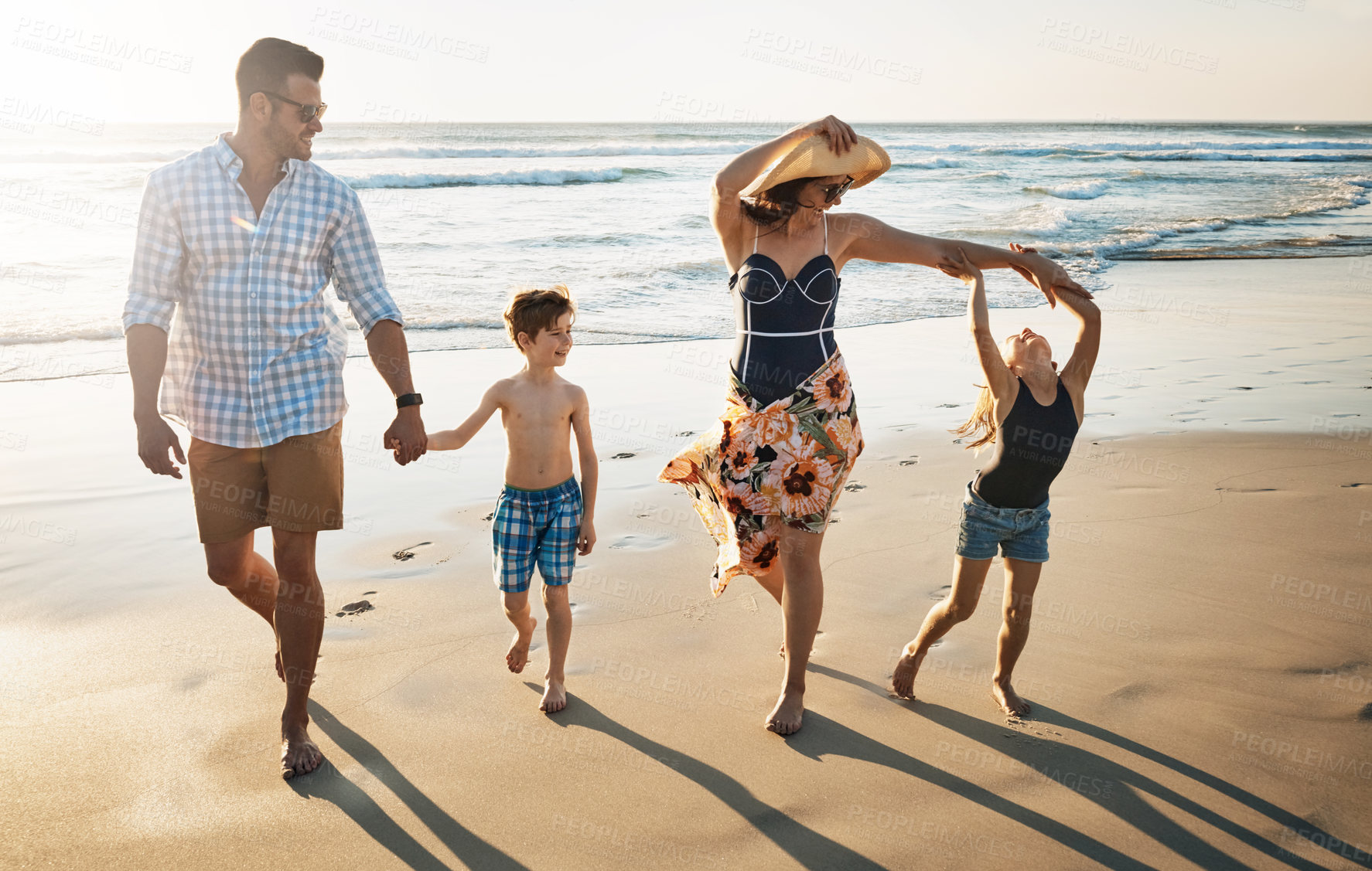 Buy stock photo Happy family, playing and holding hands with children on beach sunset for summer holiday or bonding together in nature. Mother, father and kids with smile for stroll or outdoor weekend by sand shore