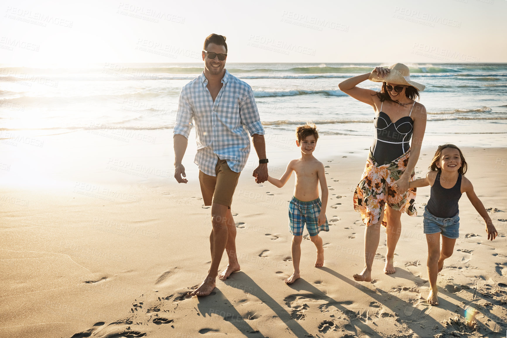 Buy stock photo Shot of a family of four spending the day at the beach