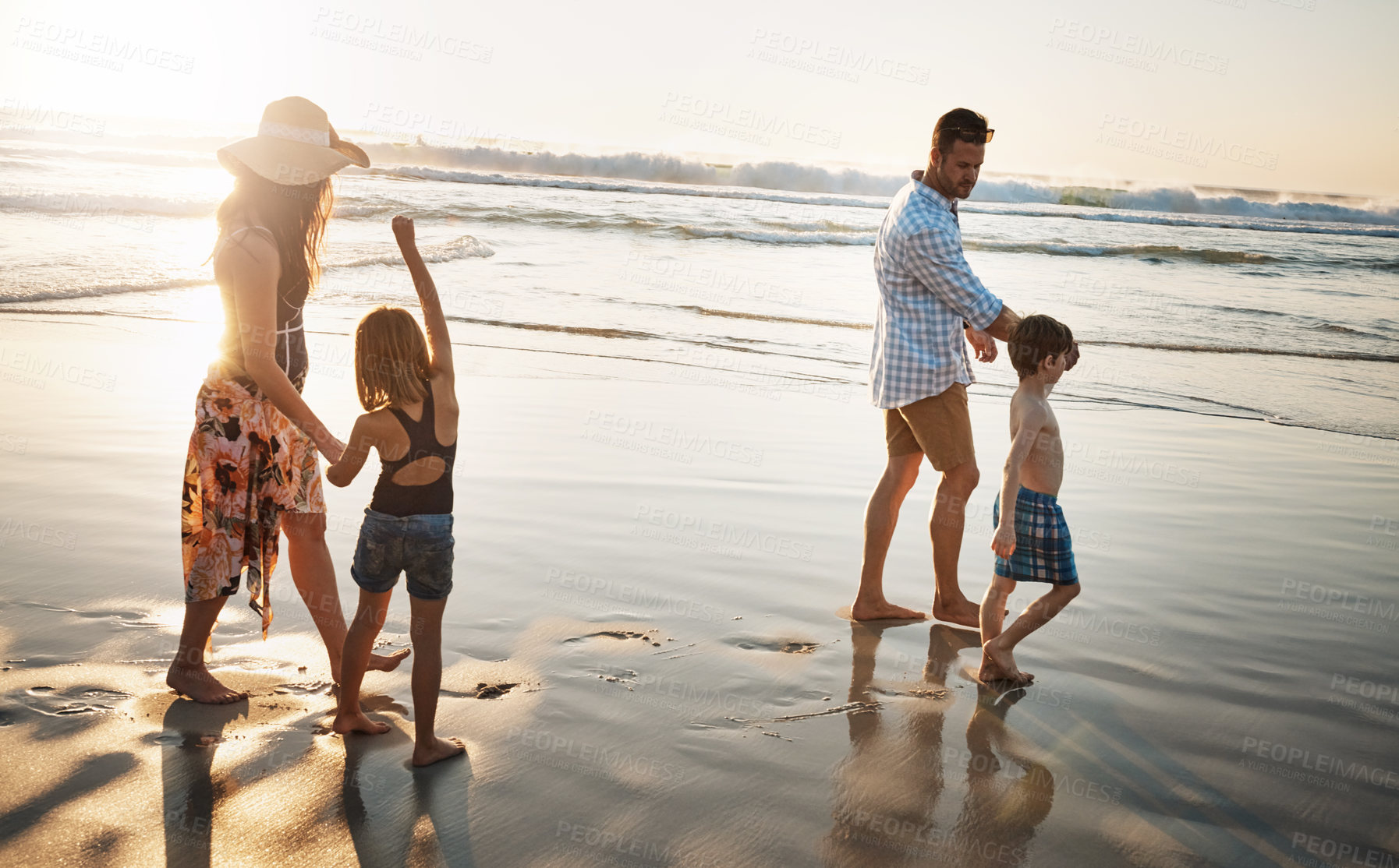 Buy stock photo Shot of a family of four spending the day at the beach