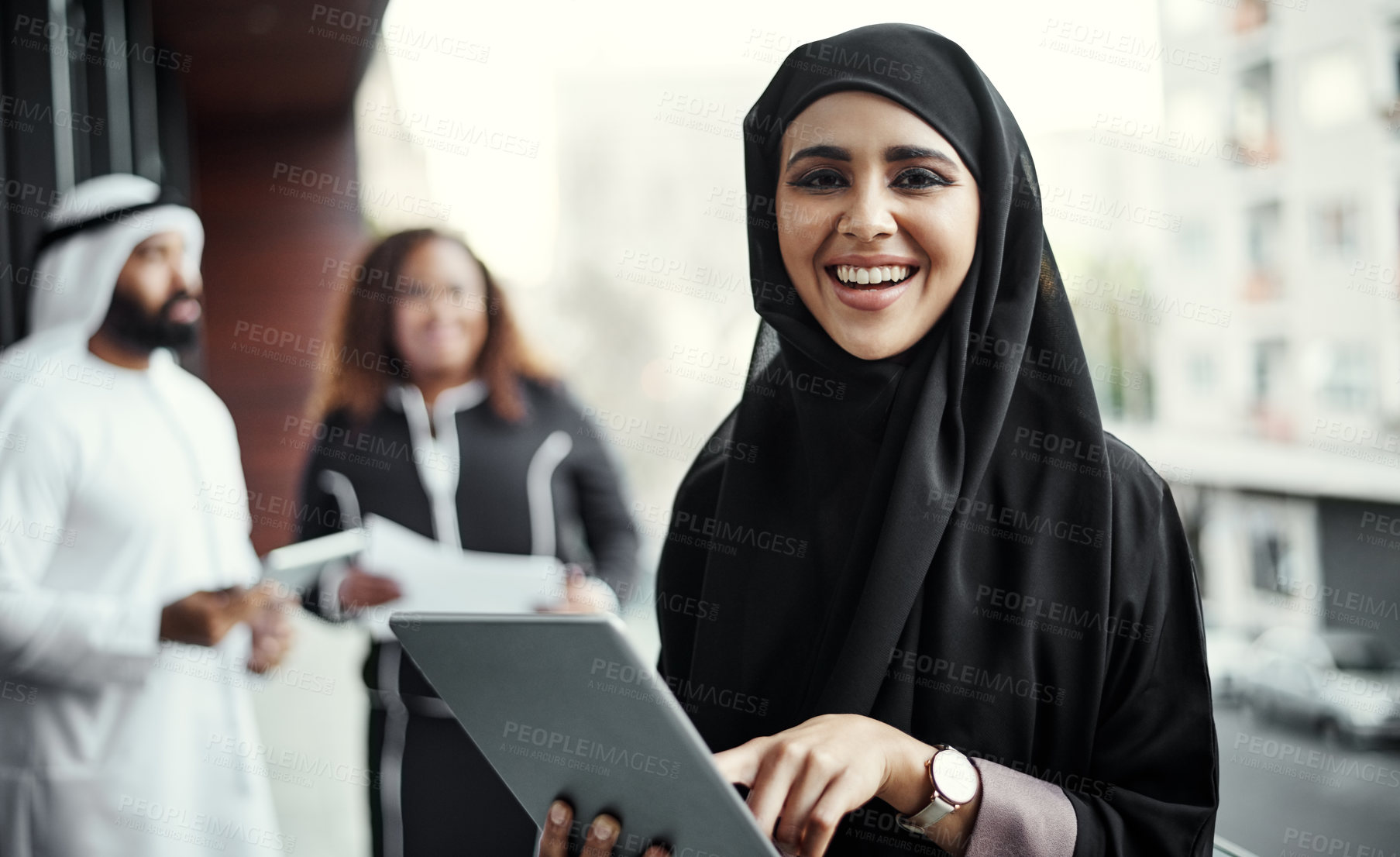 Buy stock photo Cropped portrait of an attractive young businesswoman dressed in Islamic traditional clothing using a tablet on her office balcony