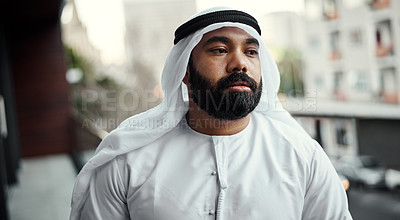 Buy stock photo Cropped shot of a businessman dressed in traditional Islamic clothing working on his office balcony