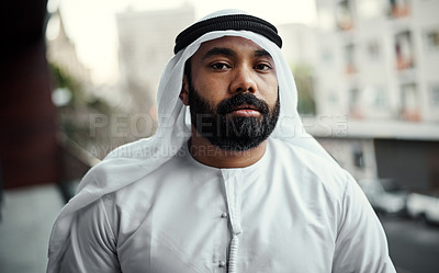 Buy stock photo Cropped portrait of a businessman dressed in traditional Islamic clothing working on his office balcony