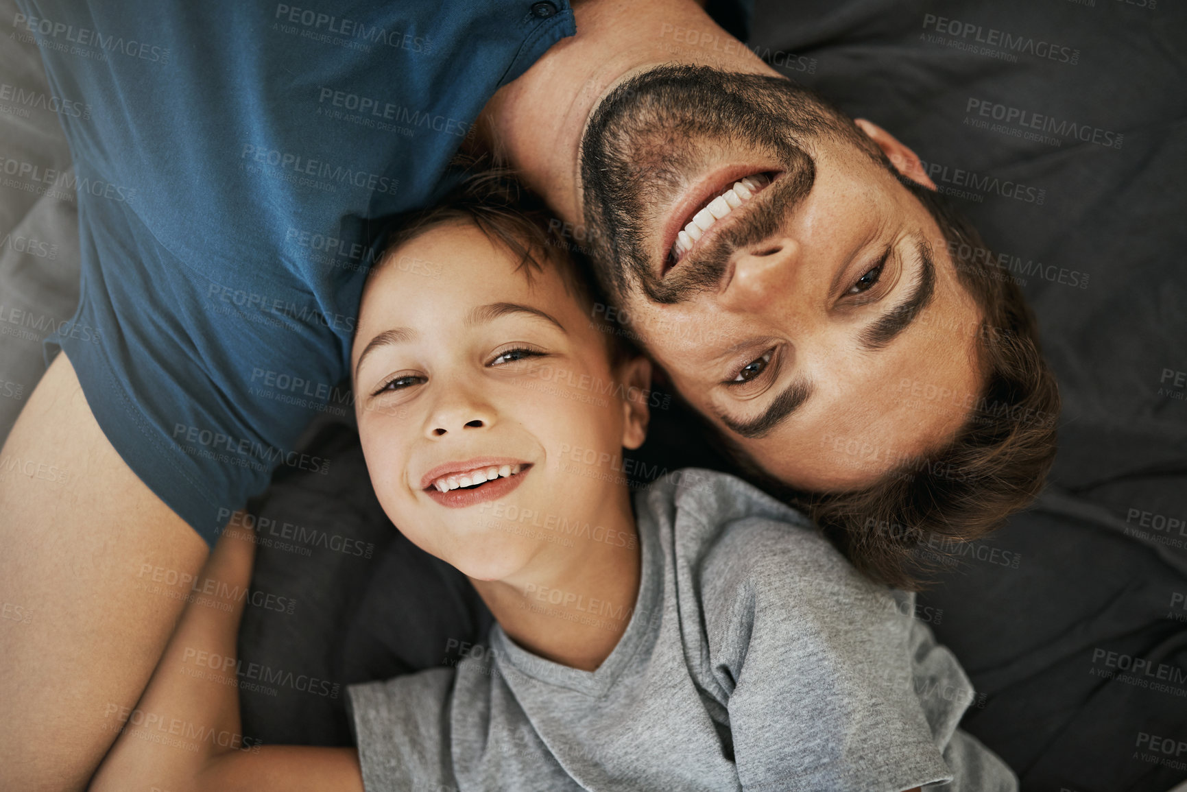 Buy stock photo Above portrait, father and son with happy for love relationship, bonding together and fun in home. Face smile, dad and young child in apartment with parent support, care and relax for lazy weekend