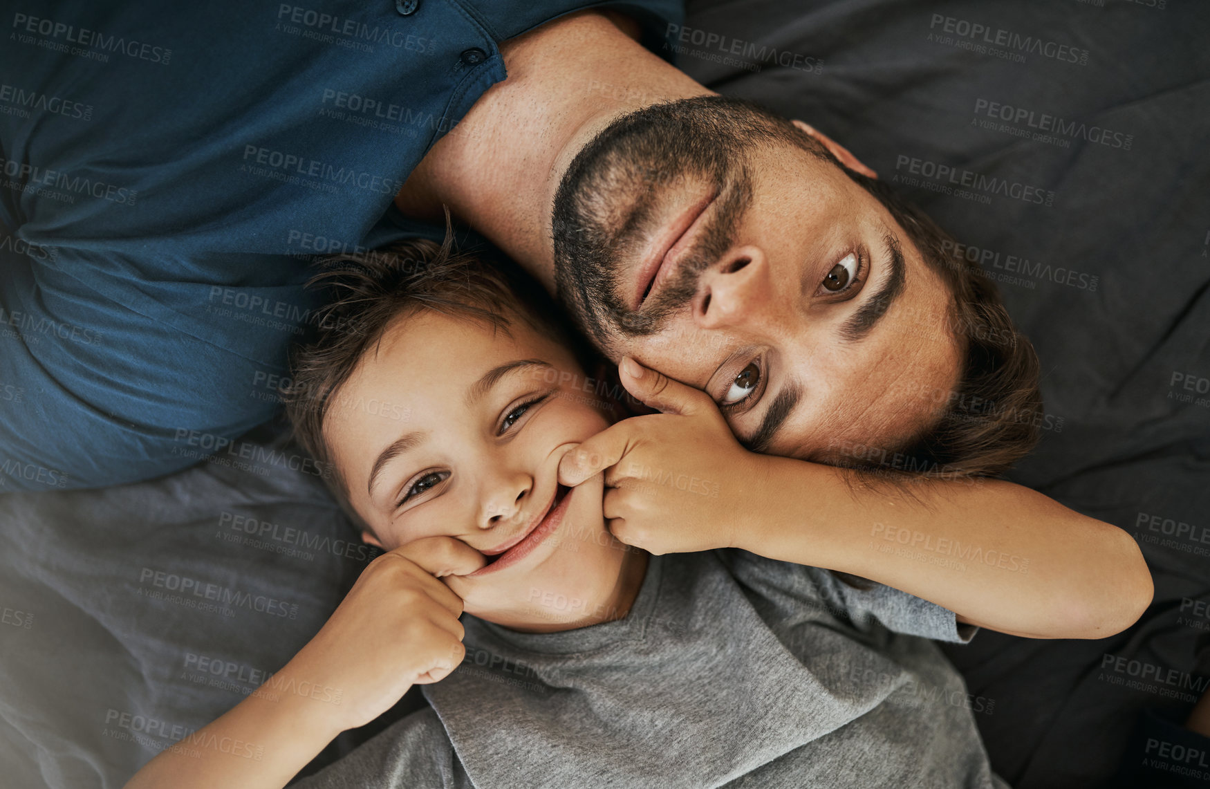 Buy stock photo Shot of a young boy and his father spending some quality time at home