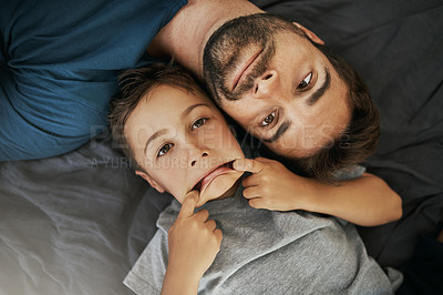 Buy stock photo Shot of young boy and his father bonding at home