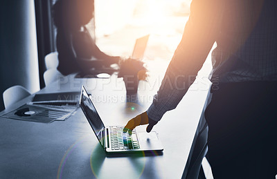 Buy stock photo Silhouette of a business man hand working on a laptop at an IT company and having a meeting in an office. A male employee typing in a dark boardroom during a meeting or presentation