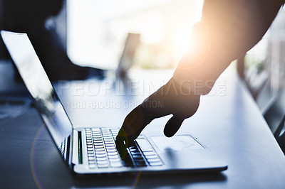 Buy stock photo Hand typing on a laptop during a business meeting in a dark office or boardroom. Closeup silhouette of a corporate professional using a computer and browsing the internet or sending an email