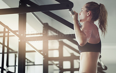 Buy stock photo Pull ups, fitness and woman with health, wellness and exercise in a gym for strong arms. Sport, lens flare and training of an athlete with focus and commitment for cardio and body wellbeing