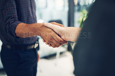 Buy stock photo Shot of two unrecognizable businesspeople shaking hands in agreement inside of the office during the day