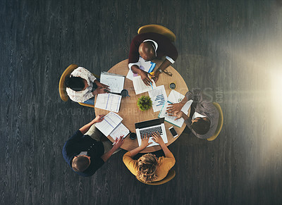 Buy stock photo High angle shot of a group of businesspeople having a meeting in a modern office