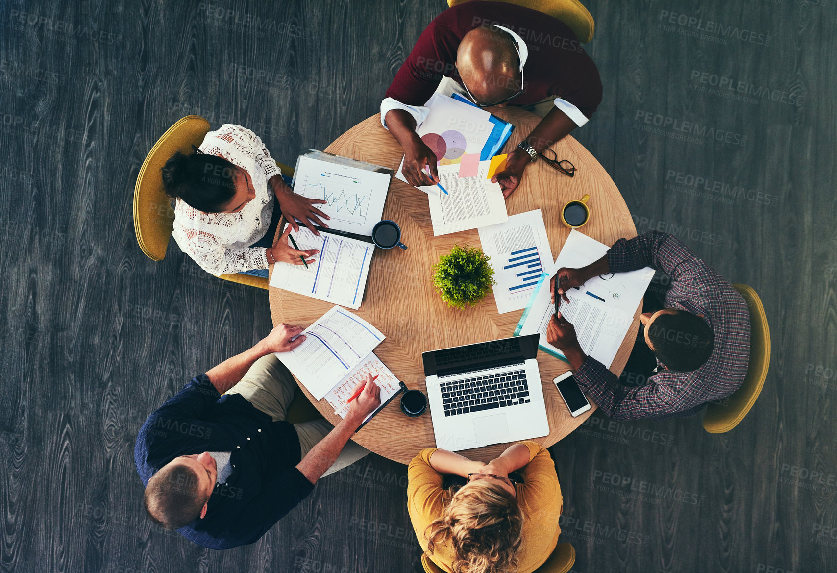 Buy stock photo High angle shot of a group of businesspeople having a meeting in a modern office