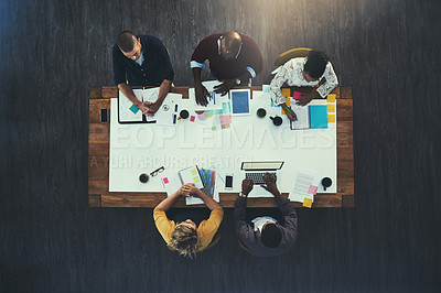 Buy stock photo High angle shot of a group of businesspeople having a meeting in a modern office