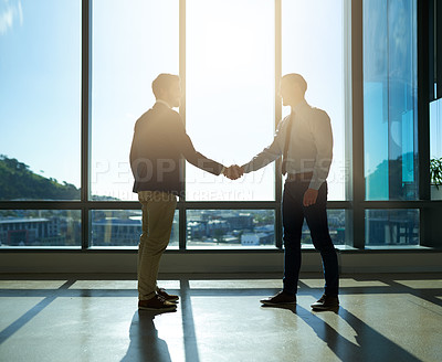Buy stock photo Full length shot of two handsome young businessmen shaking hands in the office