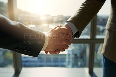 Buy stock photo Full length shot of two unrecognizable businessmen shaking hands in the office