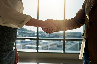 Buy stock photo Cropped shot of two unrecognizable businesspeople shaking hands in the office