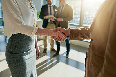 Buy stock photo Cropped shot of two unrecognizable businesspeople shaking hands during a meeting in the boardroom